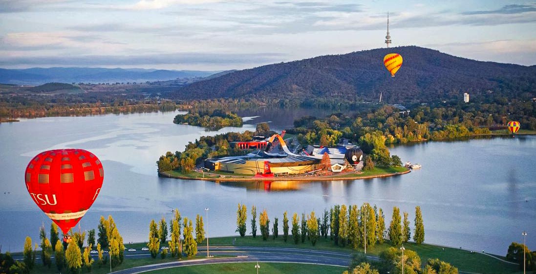Image of Lake Burley Griffin in Canberra featuring hot air balloons and the National Museum